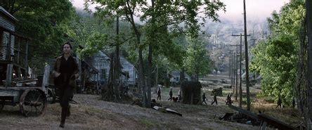How has Katniss's life in District 12 changed since the Hunger .